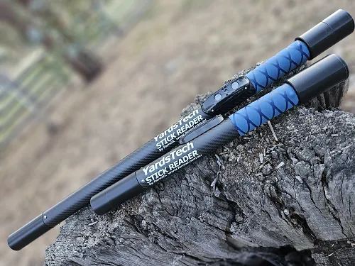Two YardsTech&reg; Stick Readers resting on a log